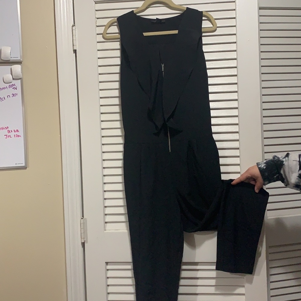 Black pantsuit with ruffle and zipper detail